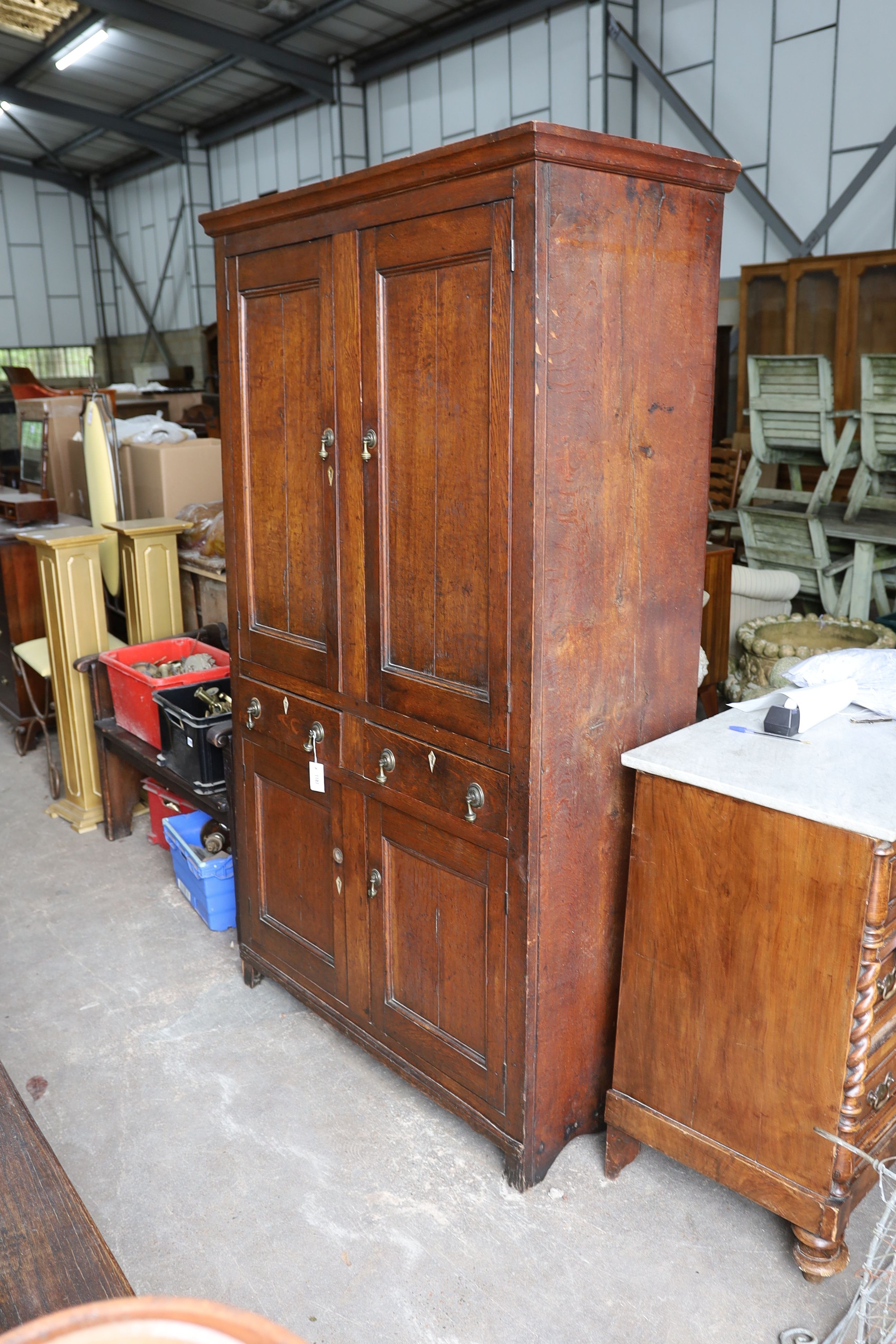 An early 19th century Welsh panelled oak household cabinet. W 116cm, D 52cm, H 200cm